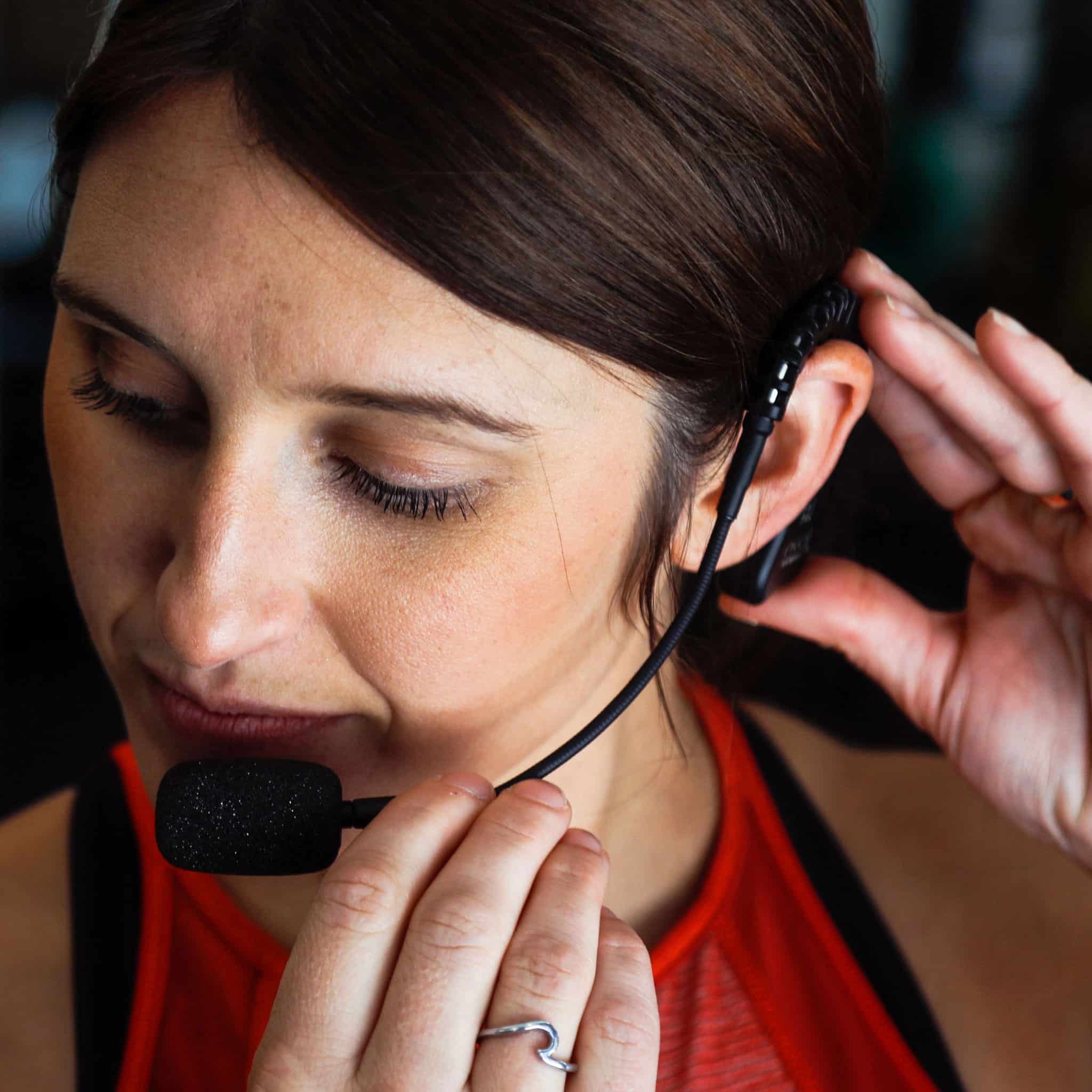 Fitness instructor adjusting the EVO cableless headset mic boom